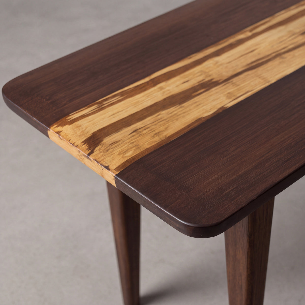 Close-up of the top and bamboo grain on the Greenington Azara Bench in Sable bamboo