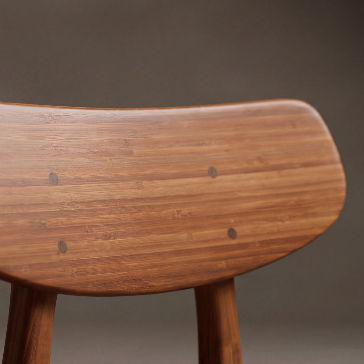 Close-up of the seat on the Greenington Cassia Dining Chair in Amber bamboo