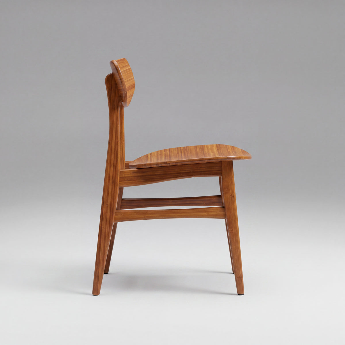 Greenington Cassia Dining Chair in Amber bamboo, on a studio background