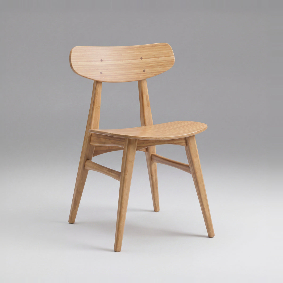 Greenington Cassia Dining Chair in Caramelized bamboo, on a grey studio background, three-quarter view