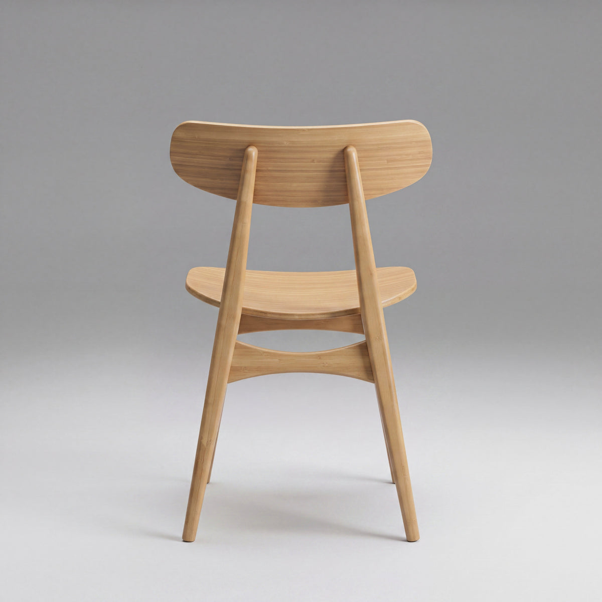 Greenington Cassia Dining Chair in Caramelized bamboo, on a grey studio background, back view