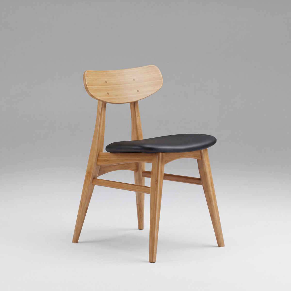 Greenington Cassia Dining Chair in Caramelized bamboo with a Black leather seat, on a studio background