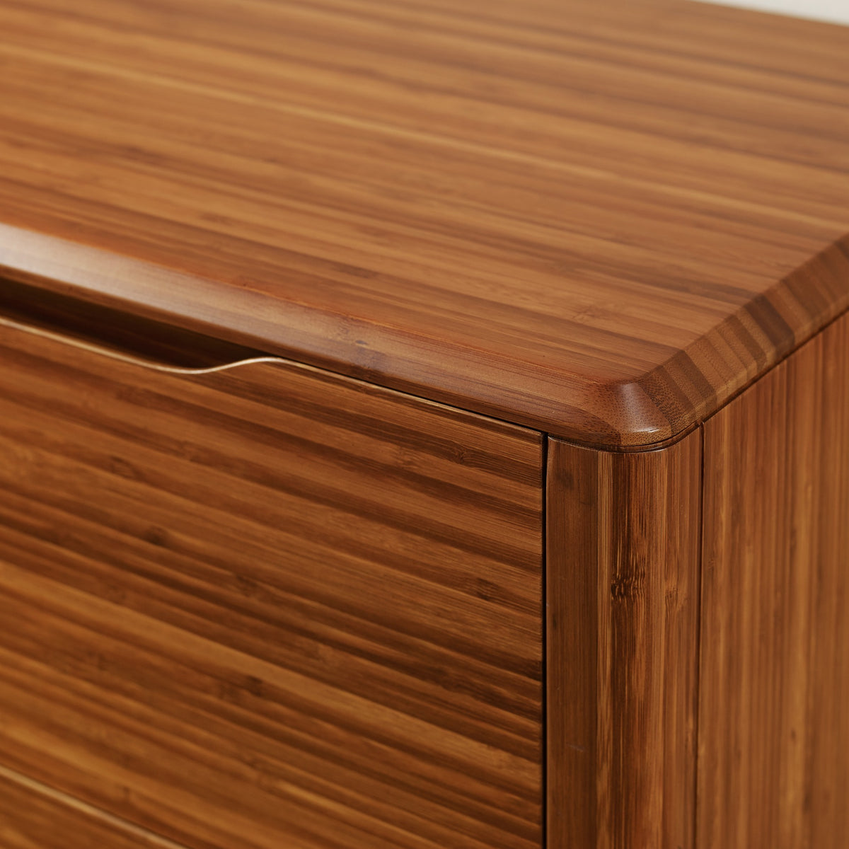 Close-up of the edge profile on the Greenington Currant Chest in Amber bamboo