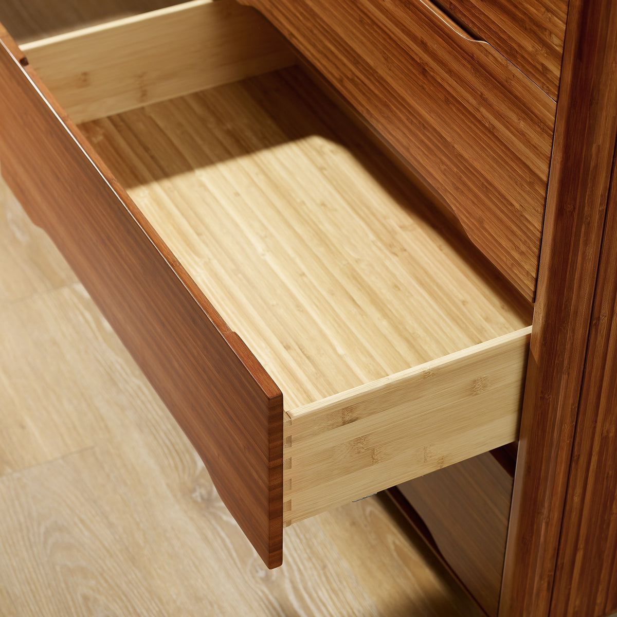 Close-up of the drawer and pull on the Greenington Currant Chest in Amber bamboo