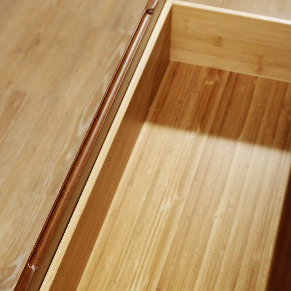 Close-up of the top and bamboo grain on the Greenington Currant Chest in Amber bamboo