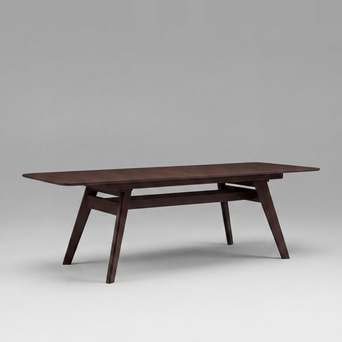 Greenington Currant Dining Table in Black Walnut bamboo, on a studio background