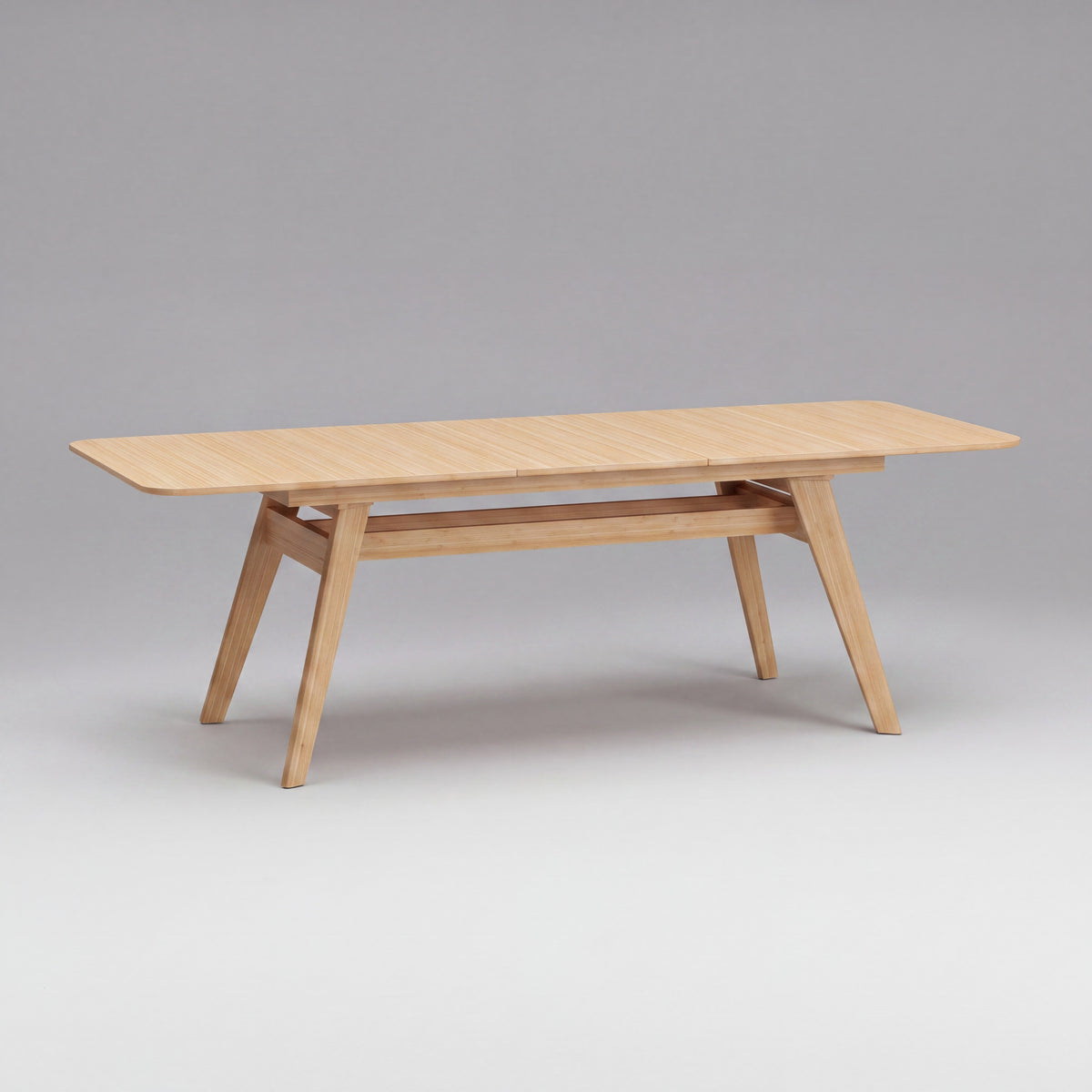 Greenington Currant Dining Table in Caramelized bamboo, on a studio background