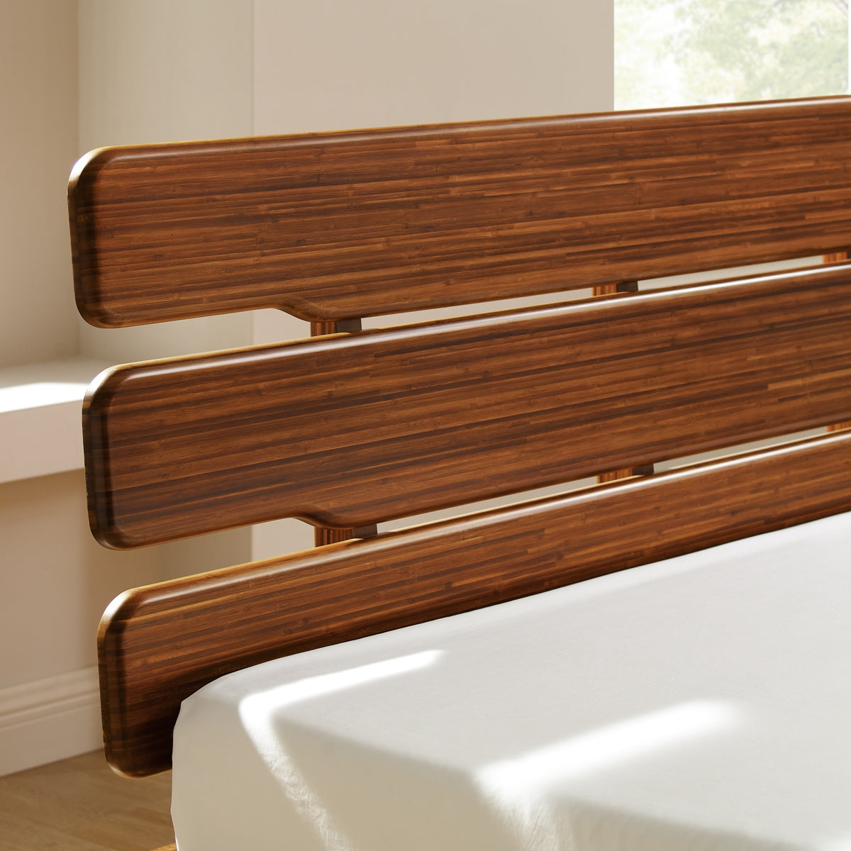 Close-up of the headboard on the Greenington Currant Platform Bed in Amber bamboo