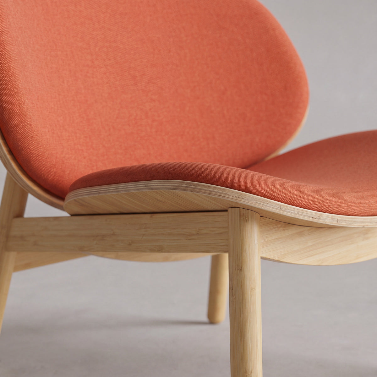 Close-up of the seat on the Greenington Danica Chair in Red fabric with a Wheat bamboo frame