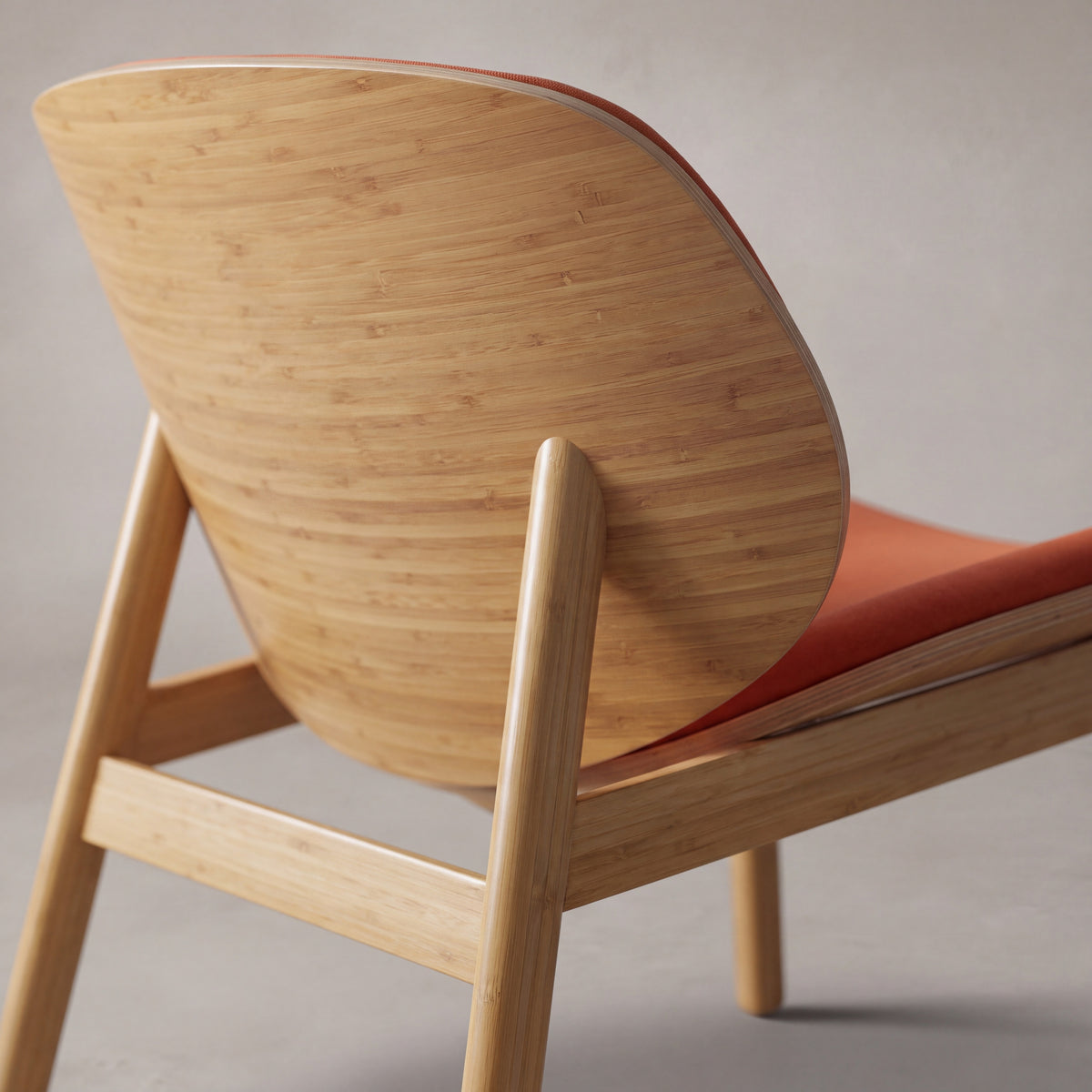 Close-up of the frame on the Greenington Danica Chair in Red fabric with a Wheat bamboo frame