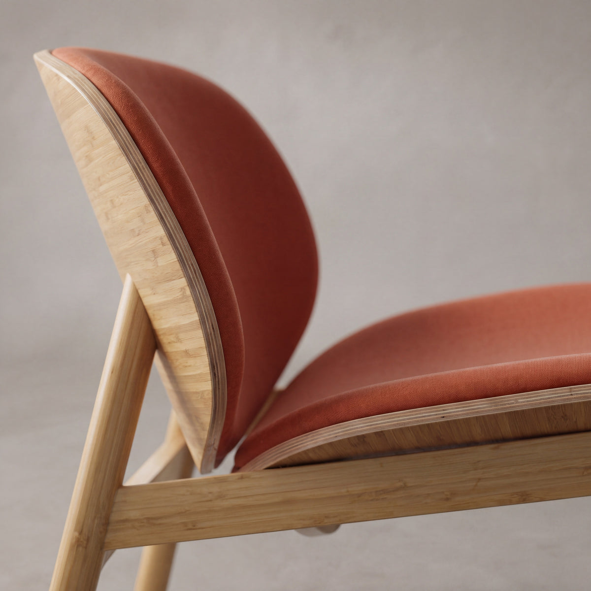 Detail of the frame on the Greenington Danica Chair in Red fabric with a Wheat bamboo frame