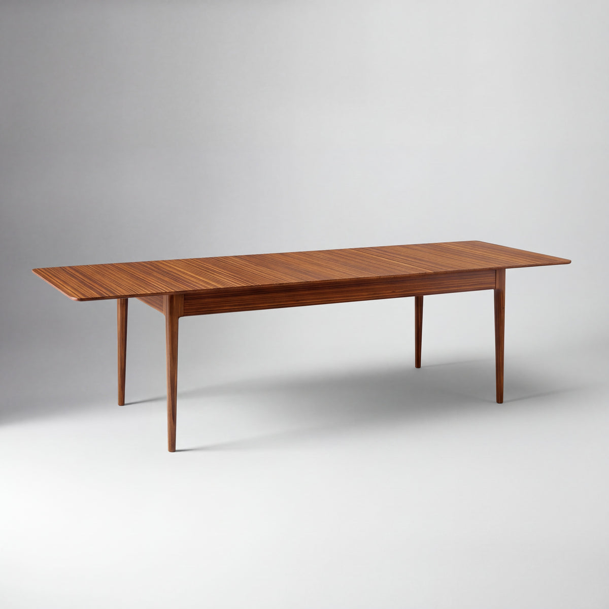 Greenington Erikka Dining Table in Amber bamboo, studio photo on a plain background