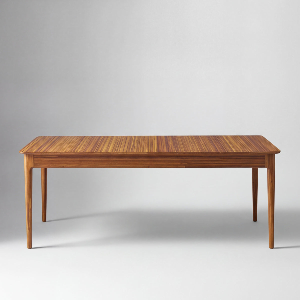 Greenington Erikka Dining Table in Amber bamboo, on a studio background