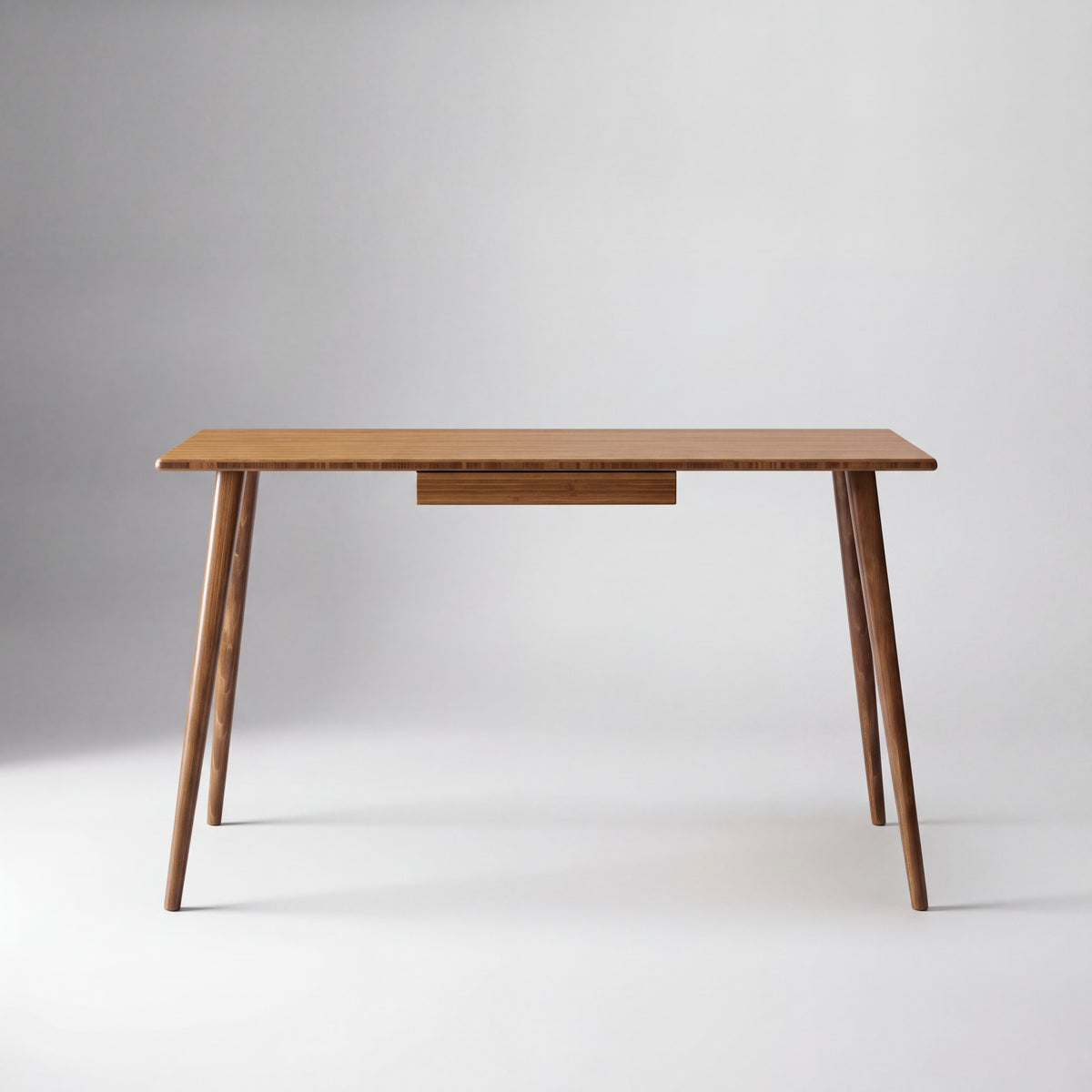 Greenington Studio Plus Desk in Amber bamboo, shown on a plain background