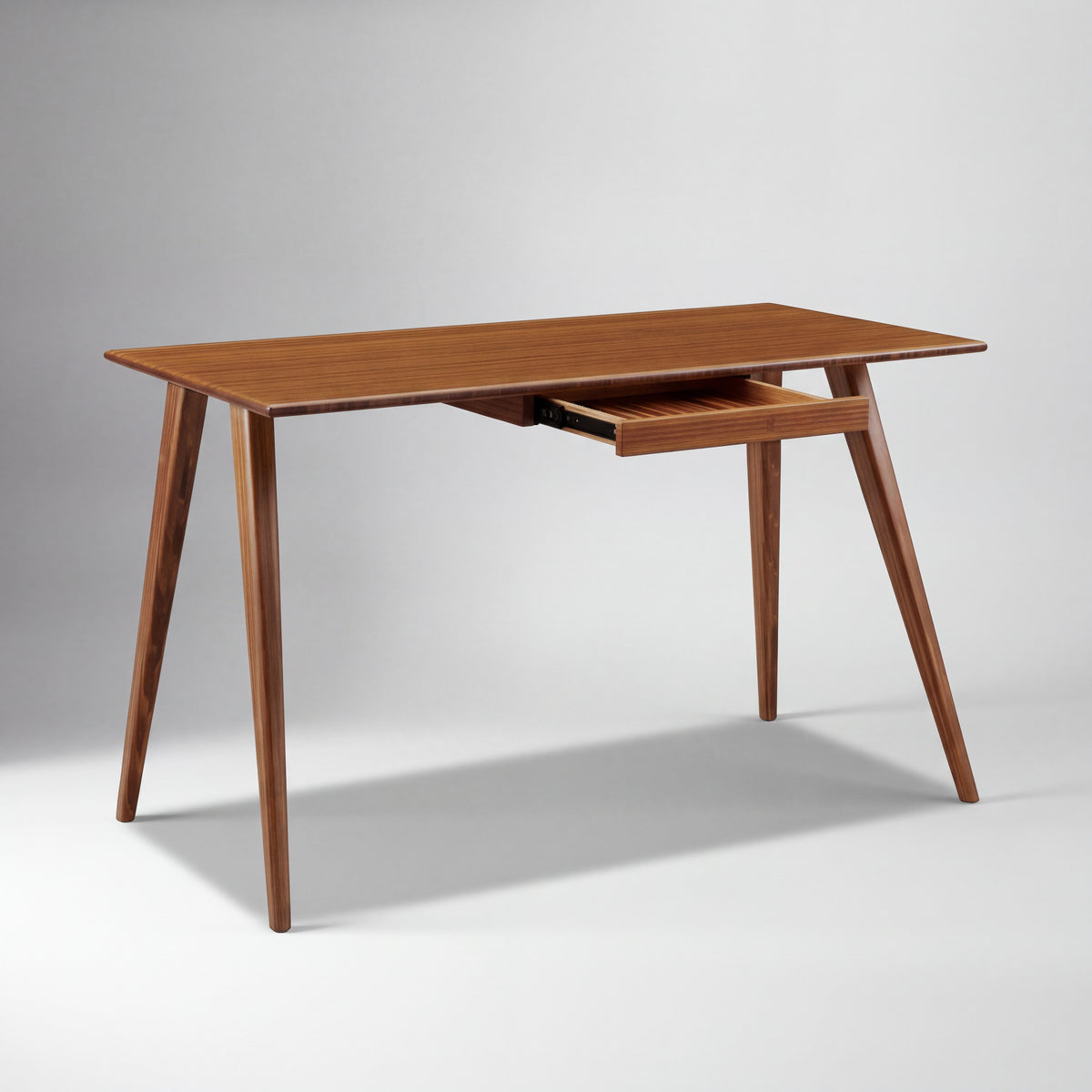 Greenington Studio Plus Desk in Amber bamboo, on a studio background