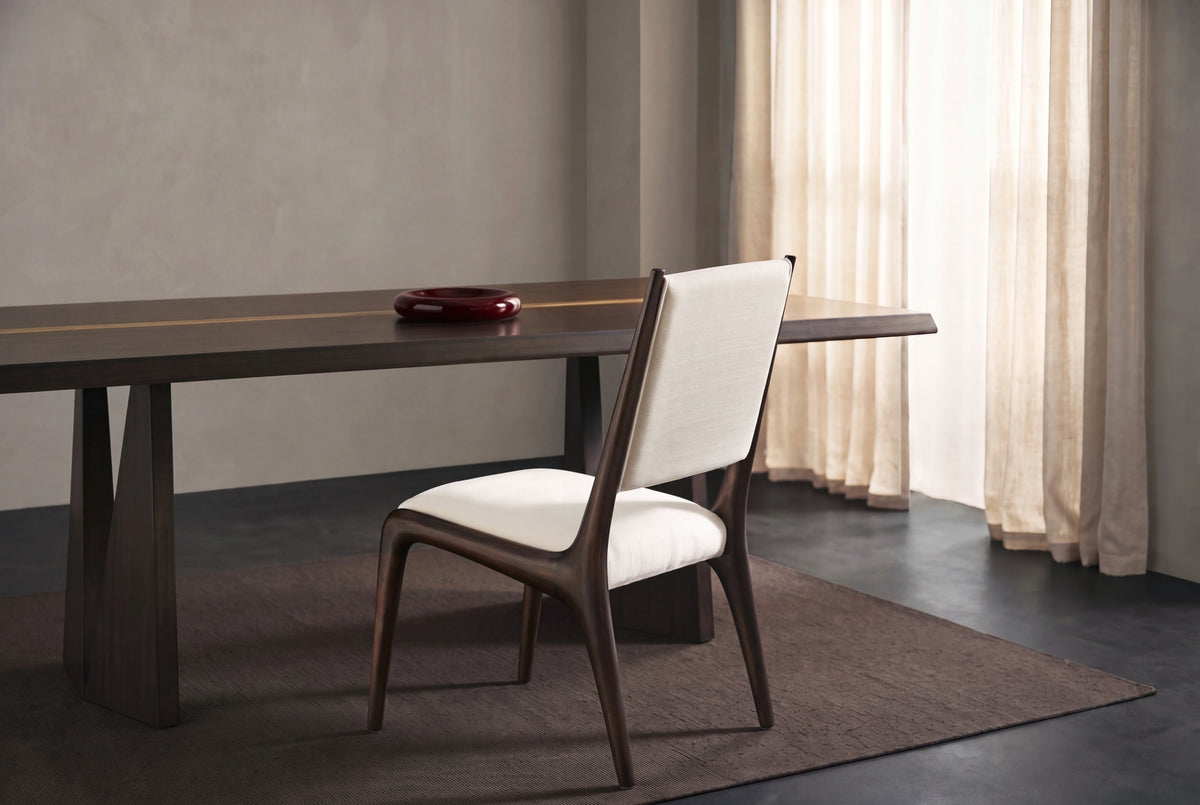 Greenington Torrey Dining Table in Black Walnut with Exotic Tiger inlay and a Torino Dining Chair in a softly lit grey plaster dining room