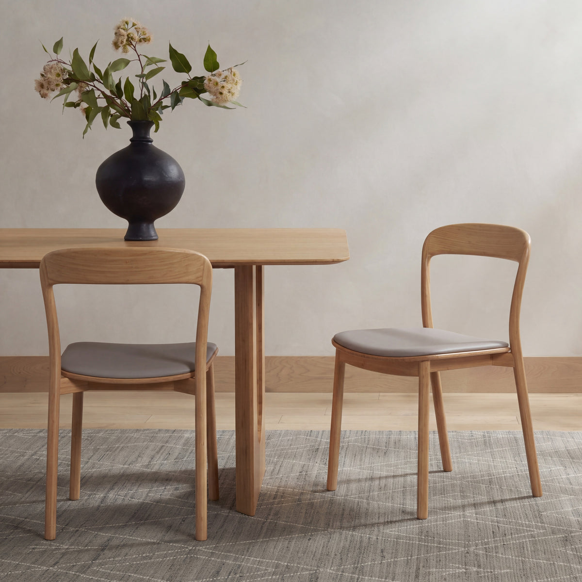 Greenington Hanna Dining Chair Leather Seat in Wheat bamboo with a Grey leather seat, in a furnished dining room