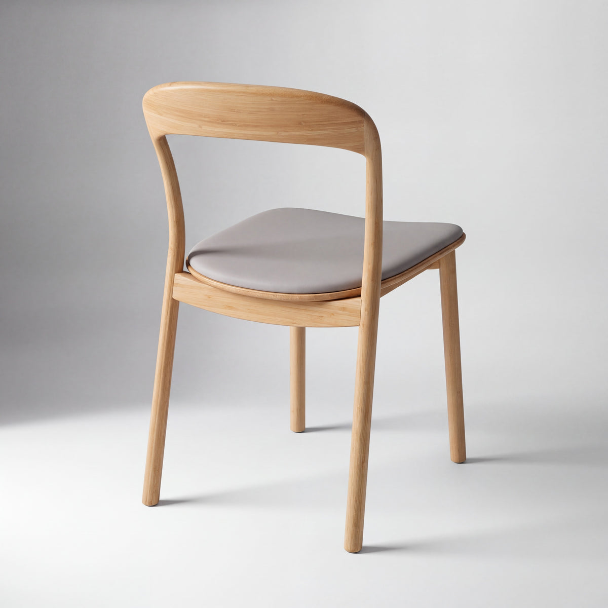 Greenington Hanna Dining Chair Leather Seat in Wheat bamboo with a Grey leather seat, on a studio background