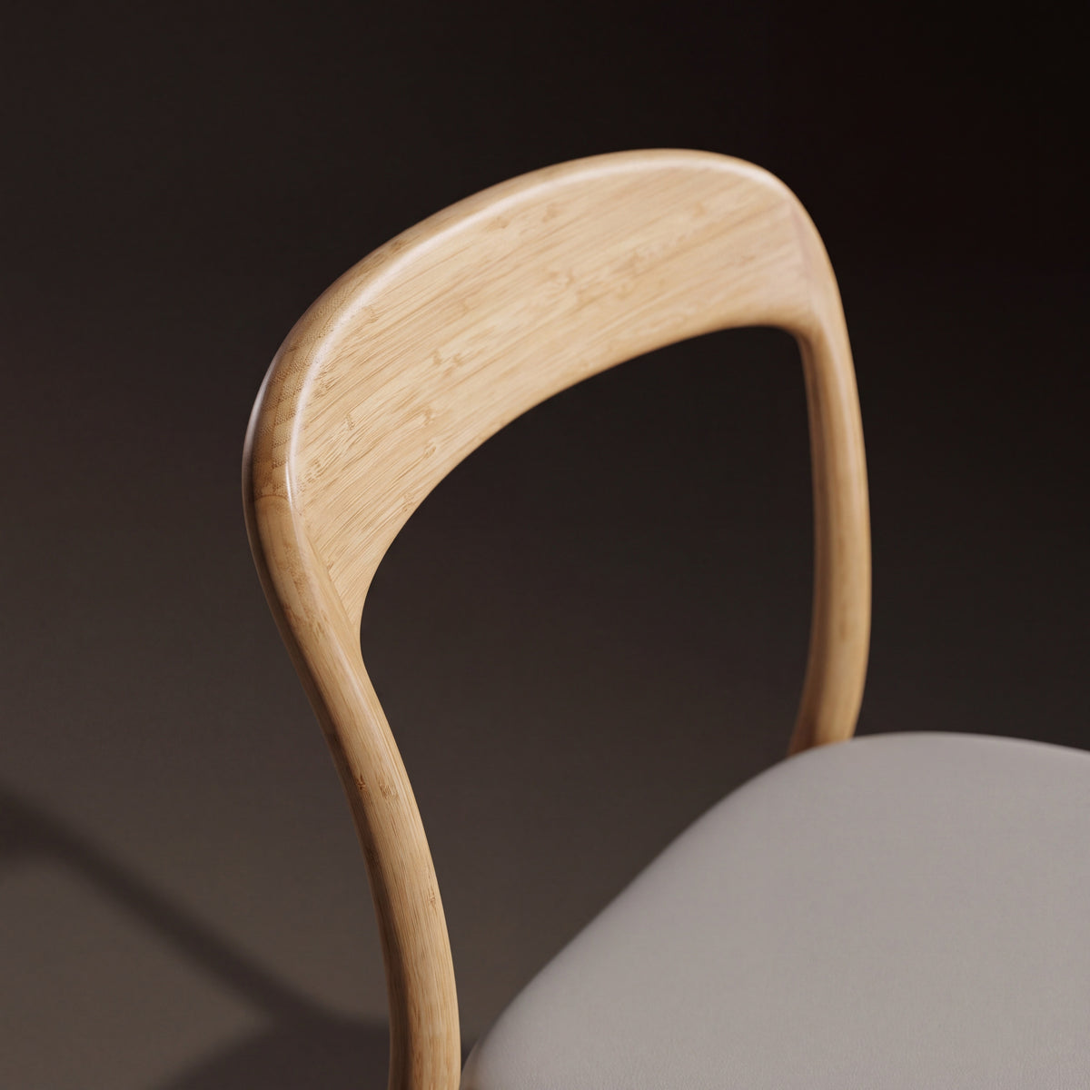 Detail of the backrest on the Greenington Hanna Dining Chair Leather Seat in Wheat bamboo with a Grey leather seat