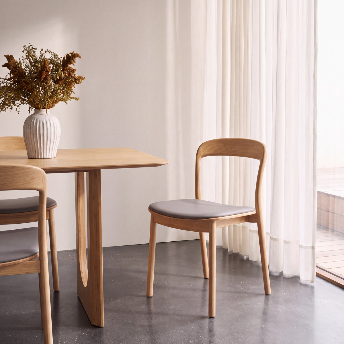 Greenington Hanna Dining Chair Leather Seat in Wheat bamboo with a Grey leather seat, styled in a dining room