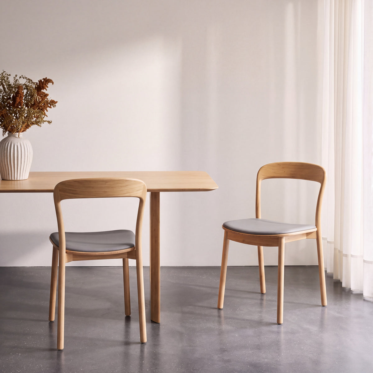 Greenington Hanna Dining Chair Leather Seat in Wheat bamboo with a Grey leather seat, shown in a dining room