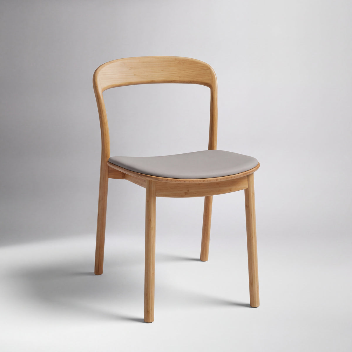 Greenington Hanna Dining Chair Leather Seat in Wheat bamboo with a Grey leather seat, on a studio background