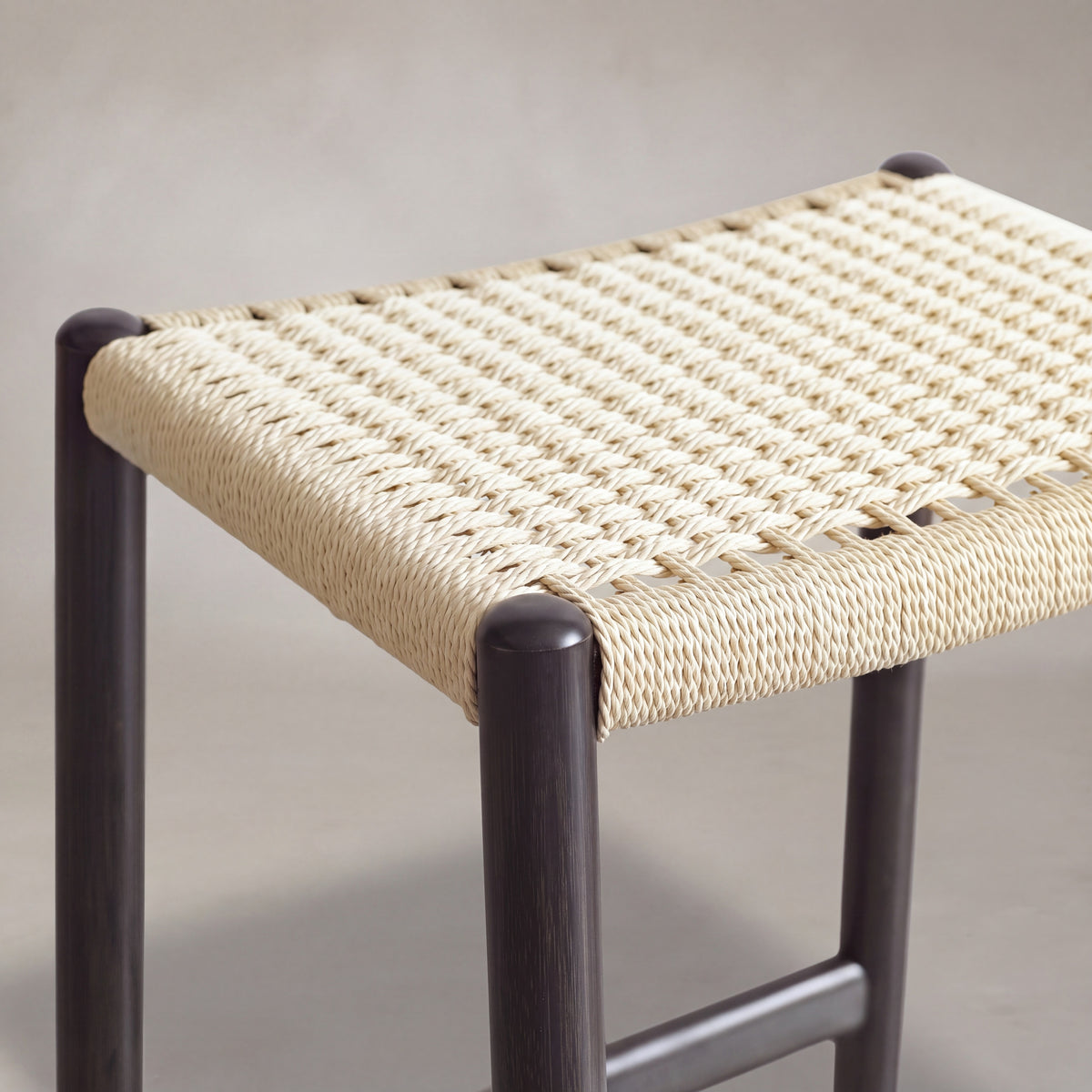 Close-up of the upholstered seat on the Greenington Leif Counter Stool in Caviar bamboo