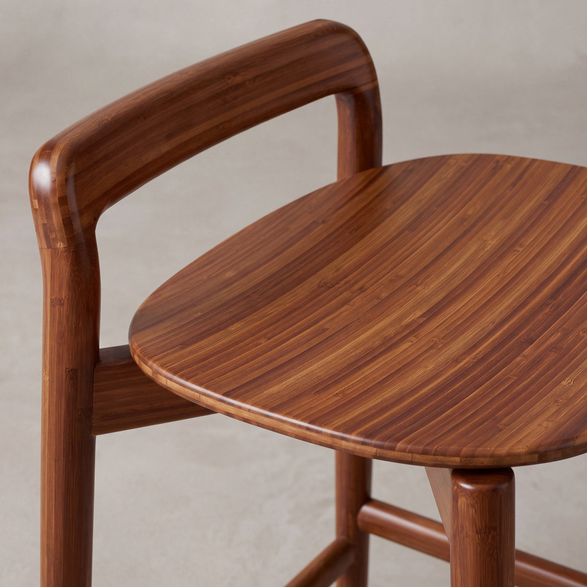 Close-up of the backrest on the Greenington Linna Counter Stool in Amber bamboo
