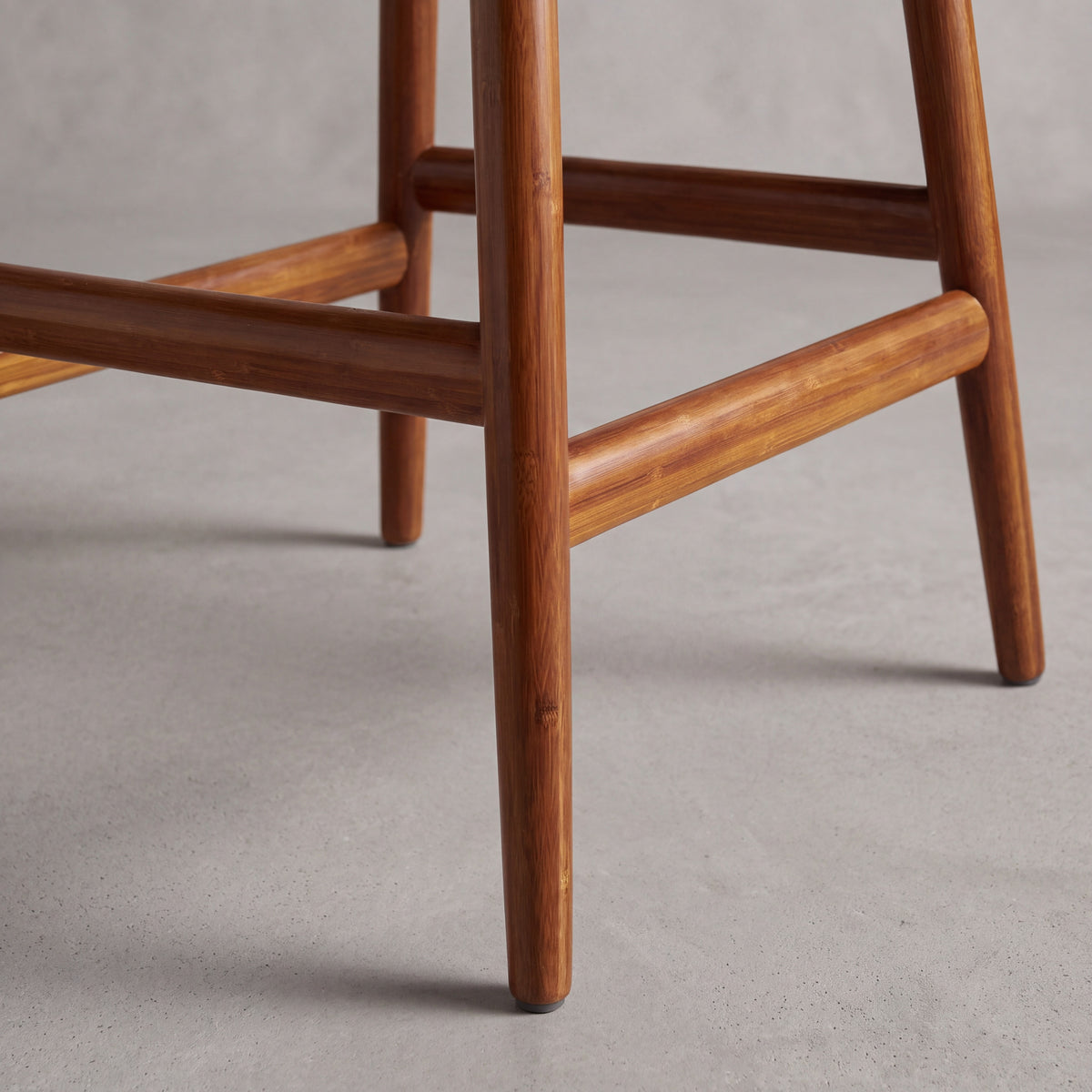 Close-up of the leg on the Greenington Linna Counter Stool in Amber bamboo