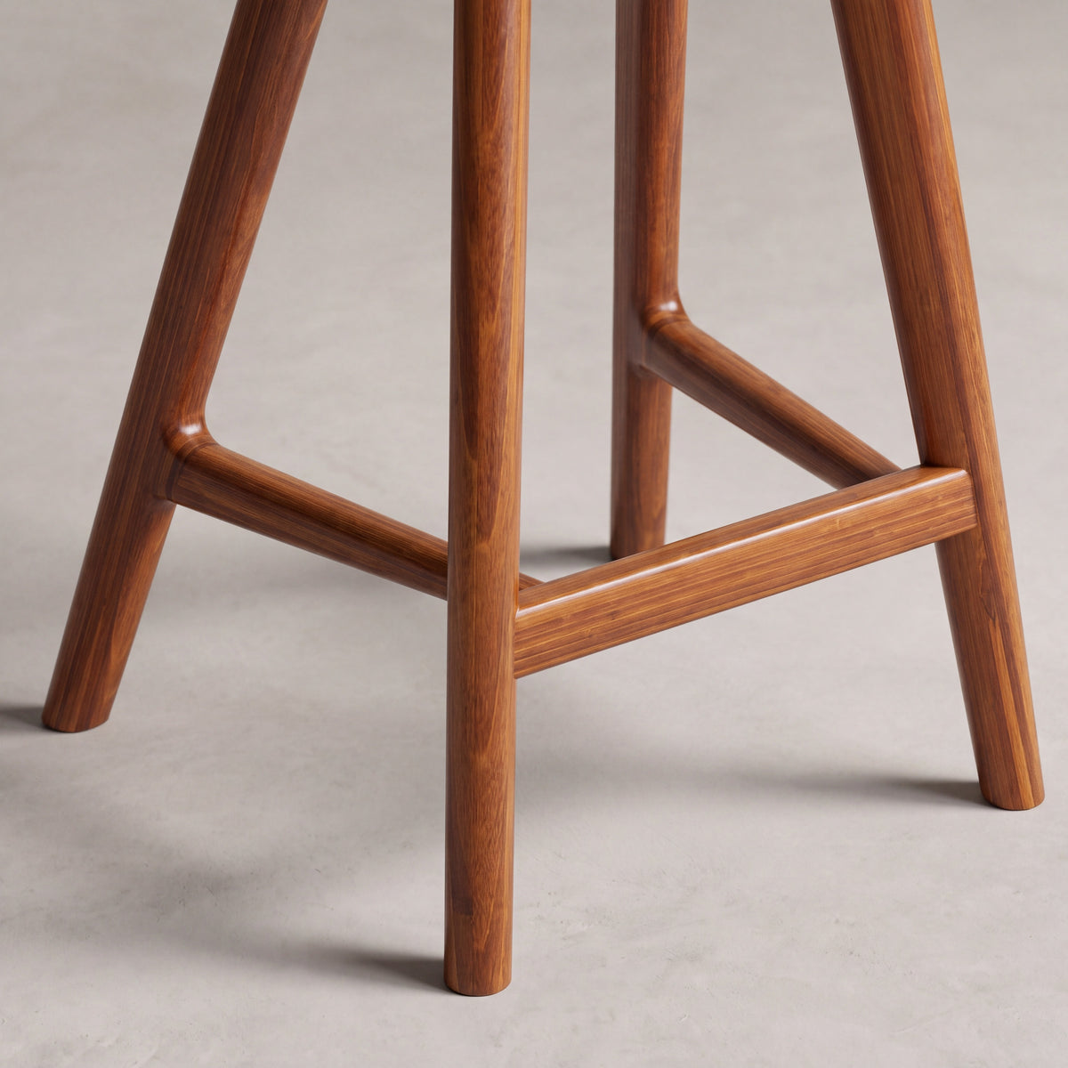 Close-up of the leg on the Greenington Max Counter Stool in Amber bamboo