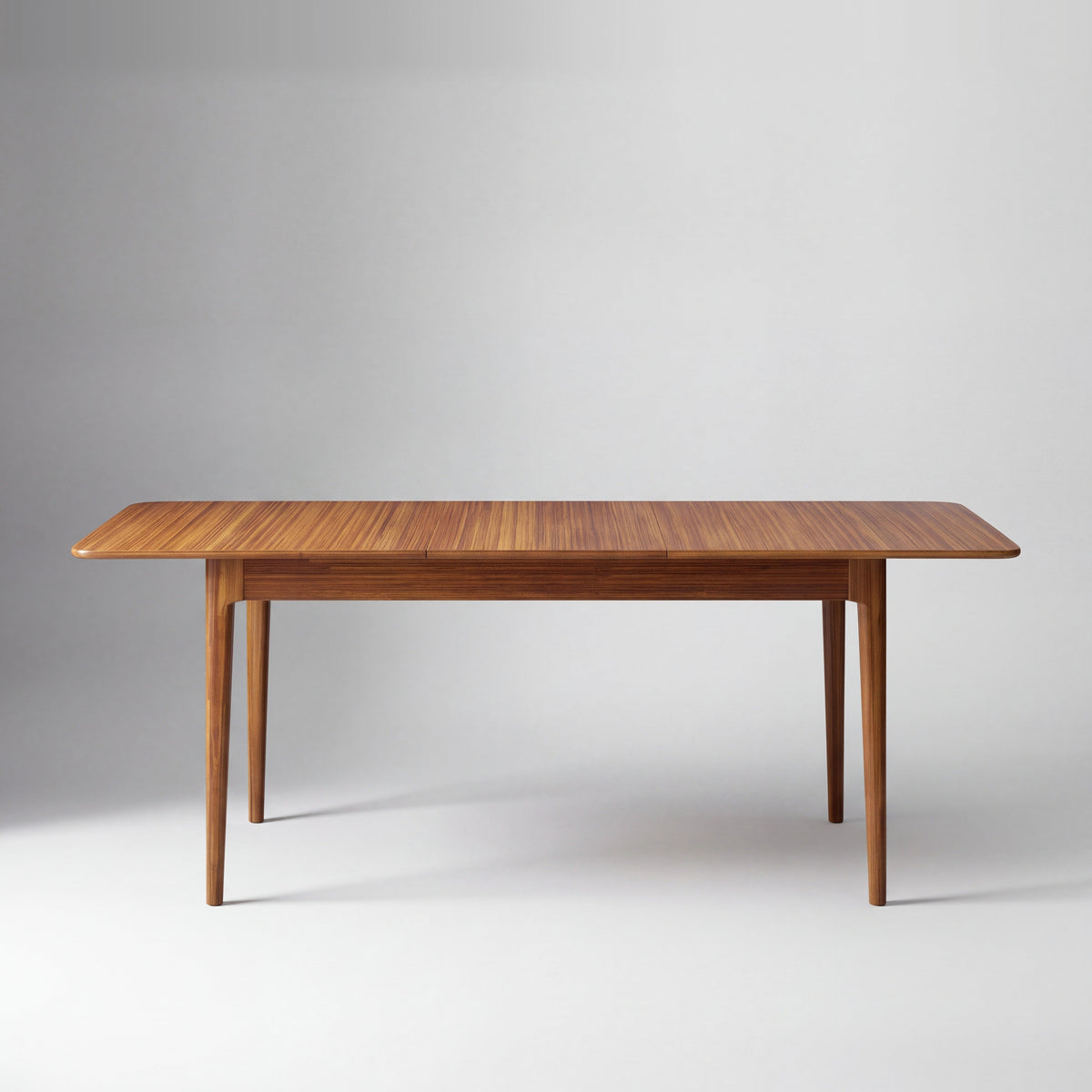 Greenington Mija Dining Table in Amber bamboo, on a studio background