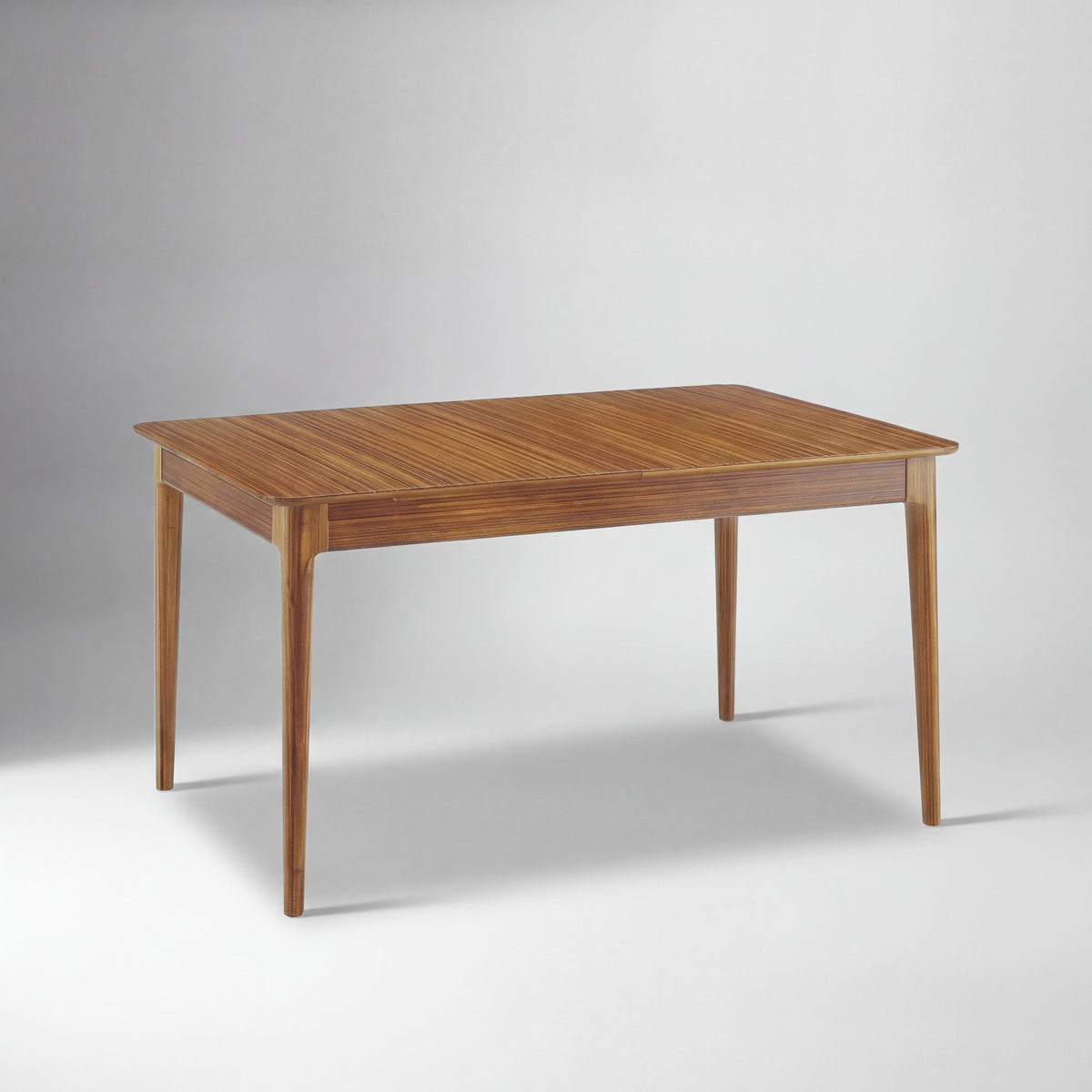 Greenington Mija Dining Table in Amber bamboo, studio photo on a plain background