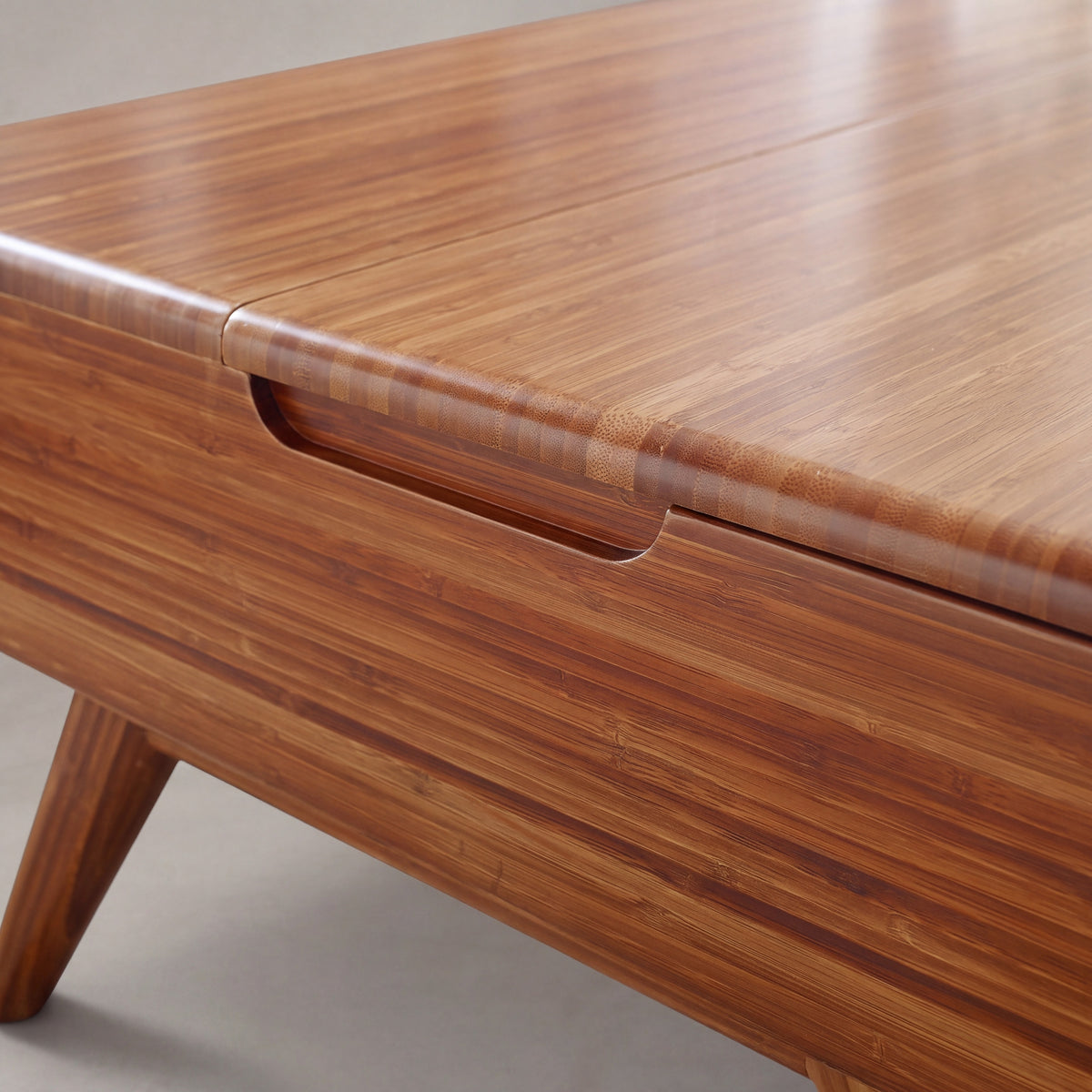 Close-up of the edge profile on the Greenington Rhody Lift Top Coffee Table in Amber bamboo