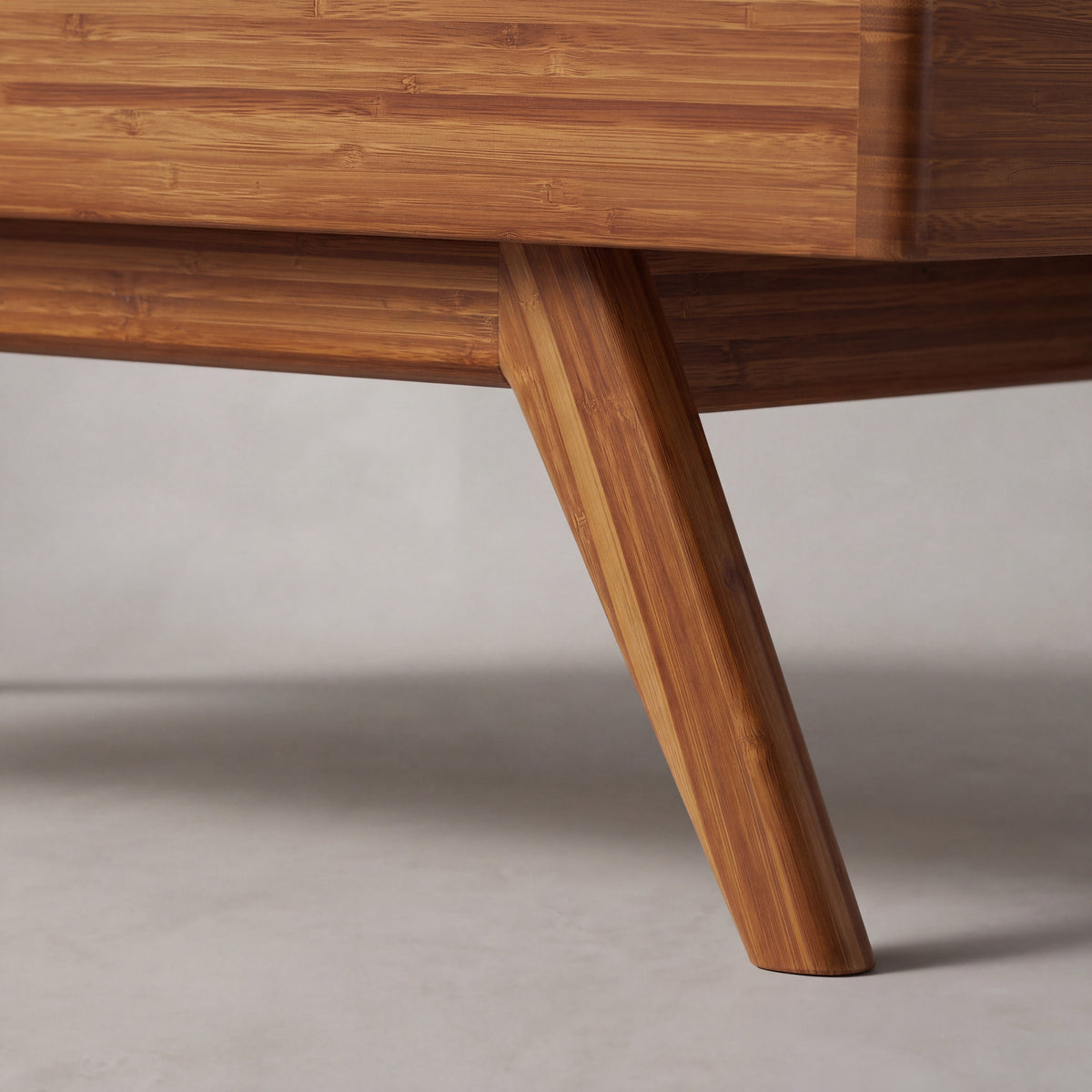 Close-up of the leg on the Greenington Rhody Lift Top Coffee Table in Amber bamboo