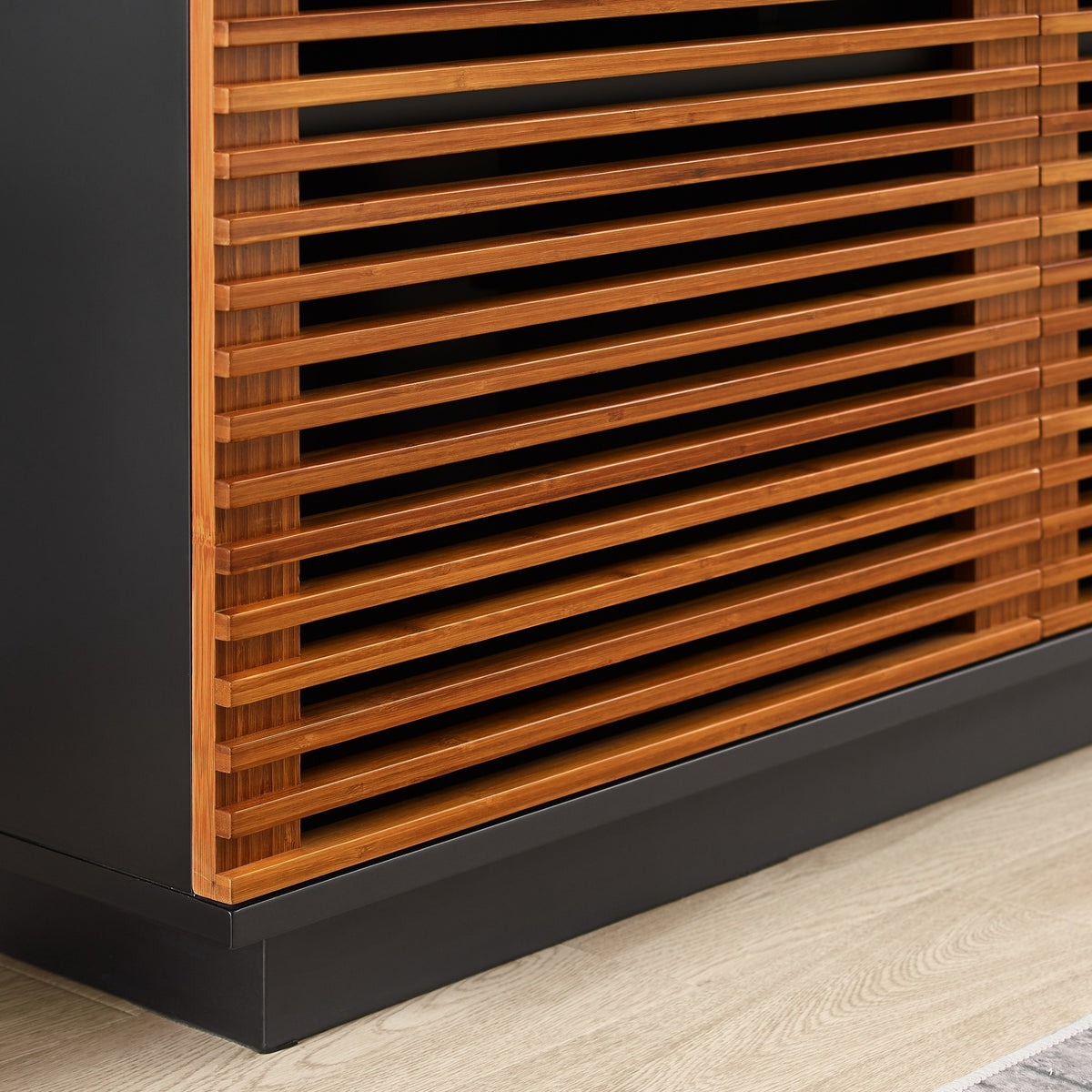 Close-up of the door and handle on the Greenington Rowan Media Center (48") in Amber bamboo
