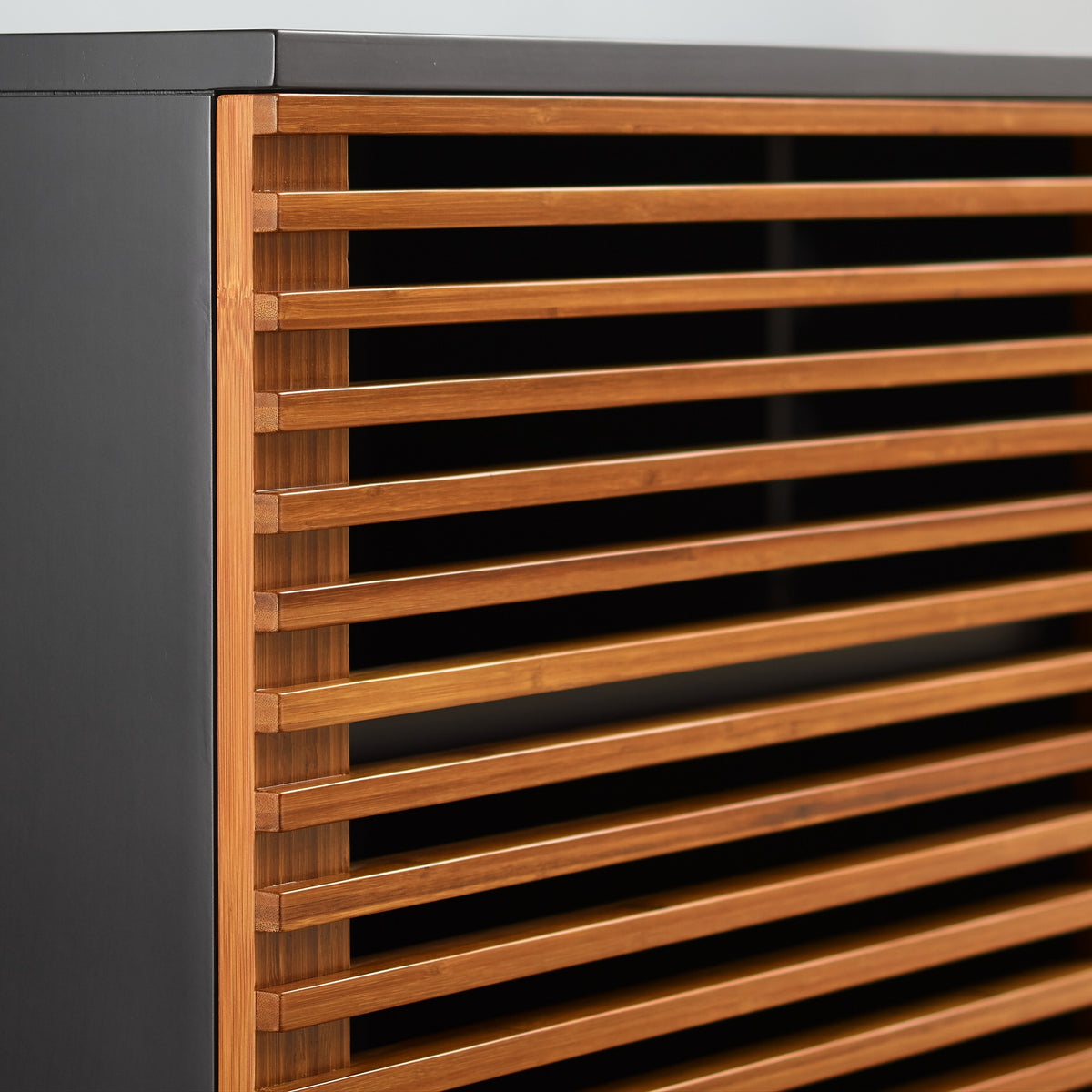 Detail of the fluted front on the Greenington Rowan Media Center (64") in Amber bamboo