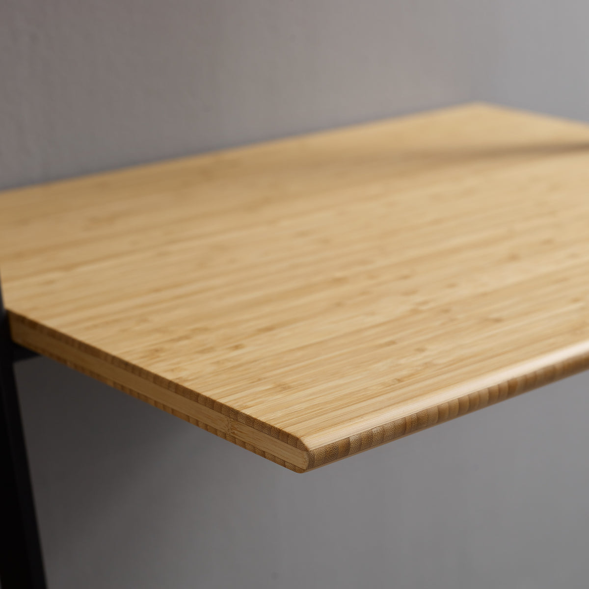 Close-up of the top and bamboo grain on the Greenington Santa Cruz Leaning Desk in Wheat bamboo