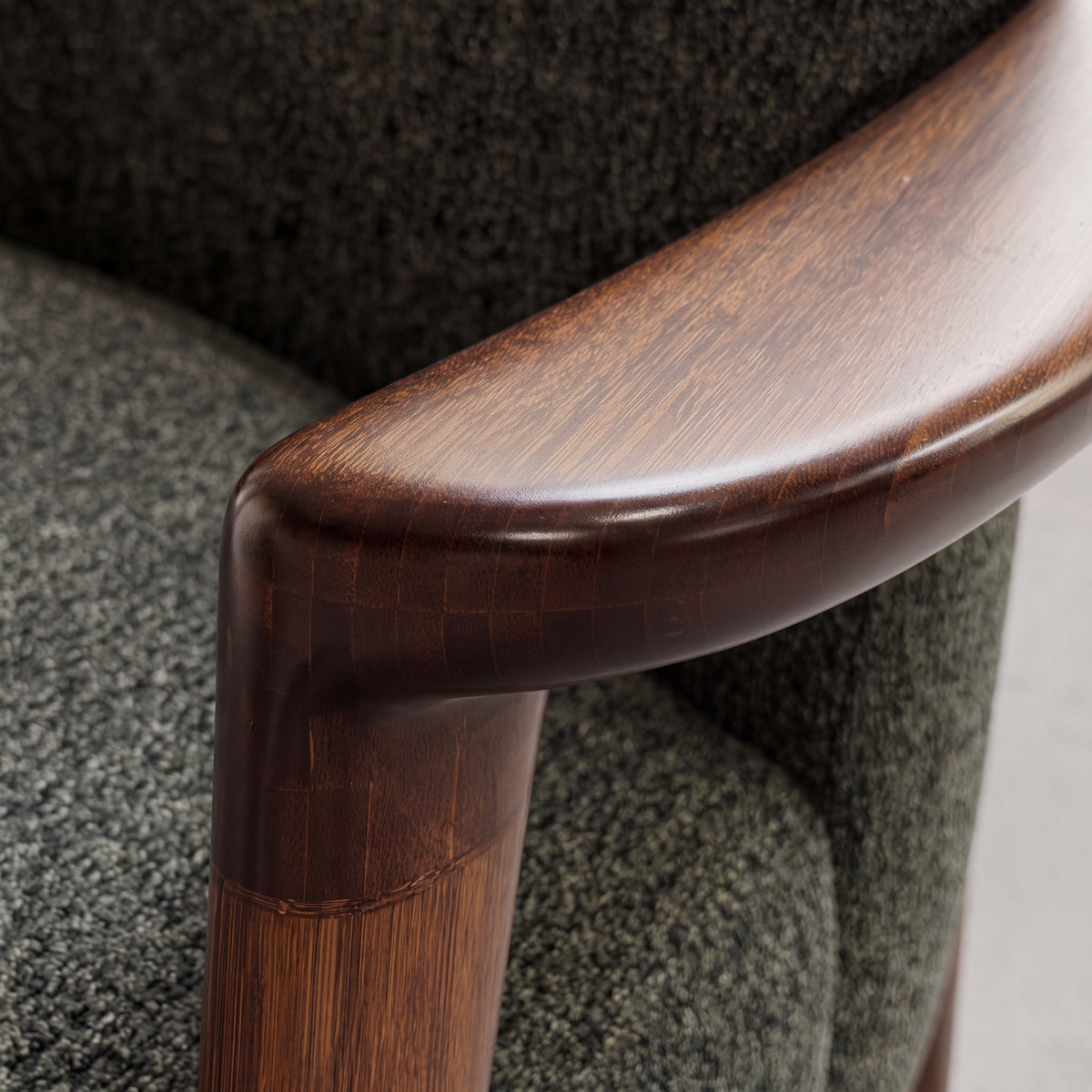 Close-up of the frame on the Greenington Skylar Lounge Chair in Black Walnut bamboo with Forest fabric