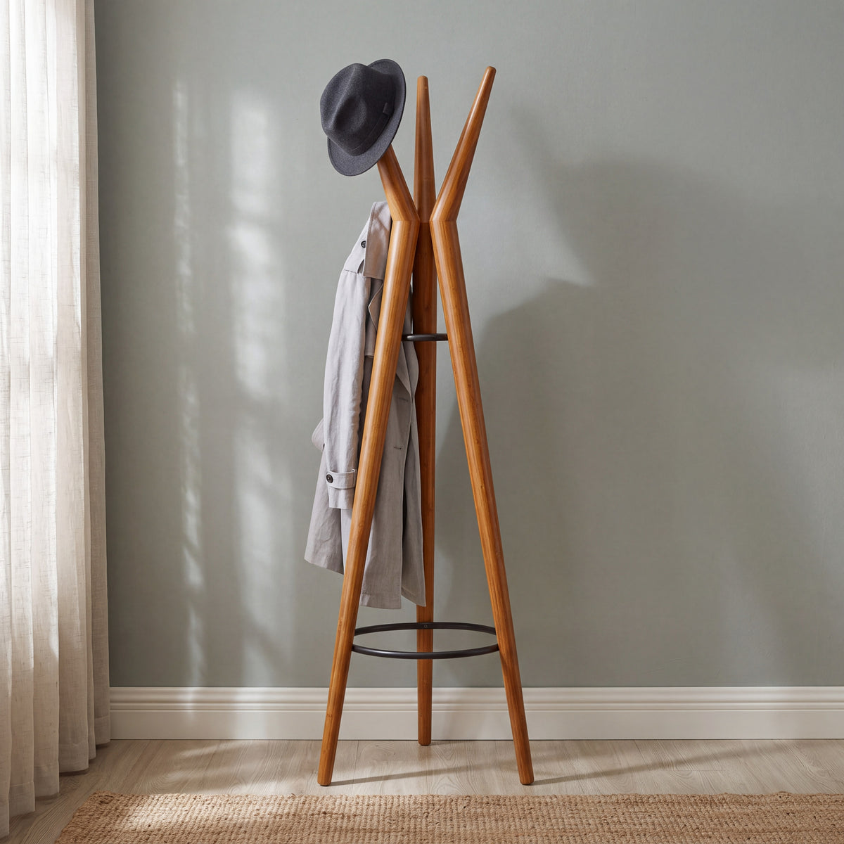 Greenington Spire Coat Tree in solid bamboo, shown in a furnished room