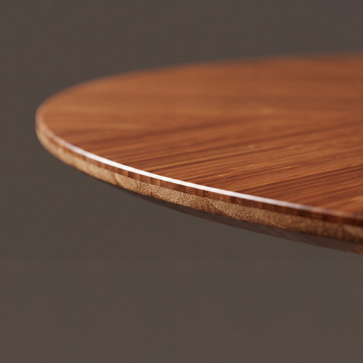 Close-up of the edge profile on the Greenington Stella Dining Table in Amber bamboo
