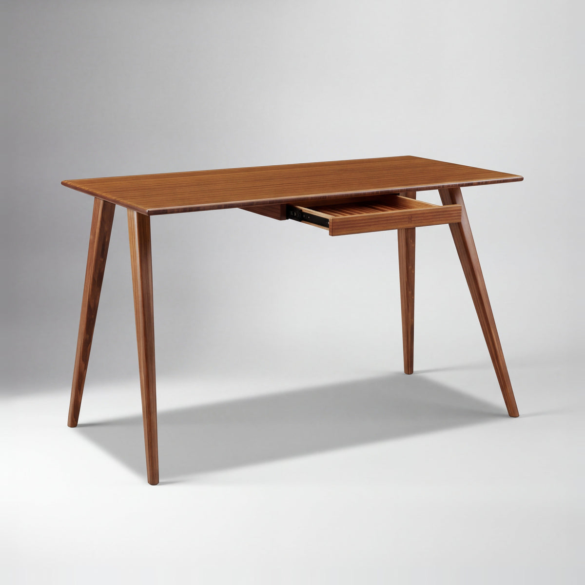 Greenington Studio Plus Desk in Amber bamboo, on a studio background