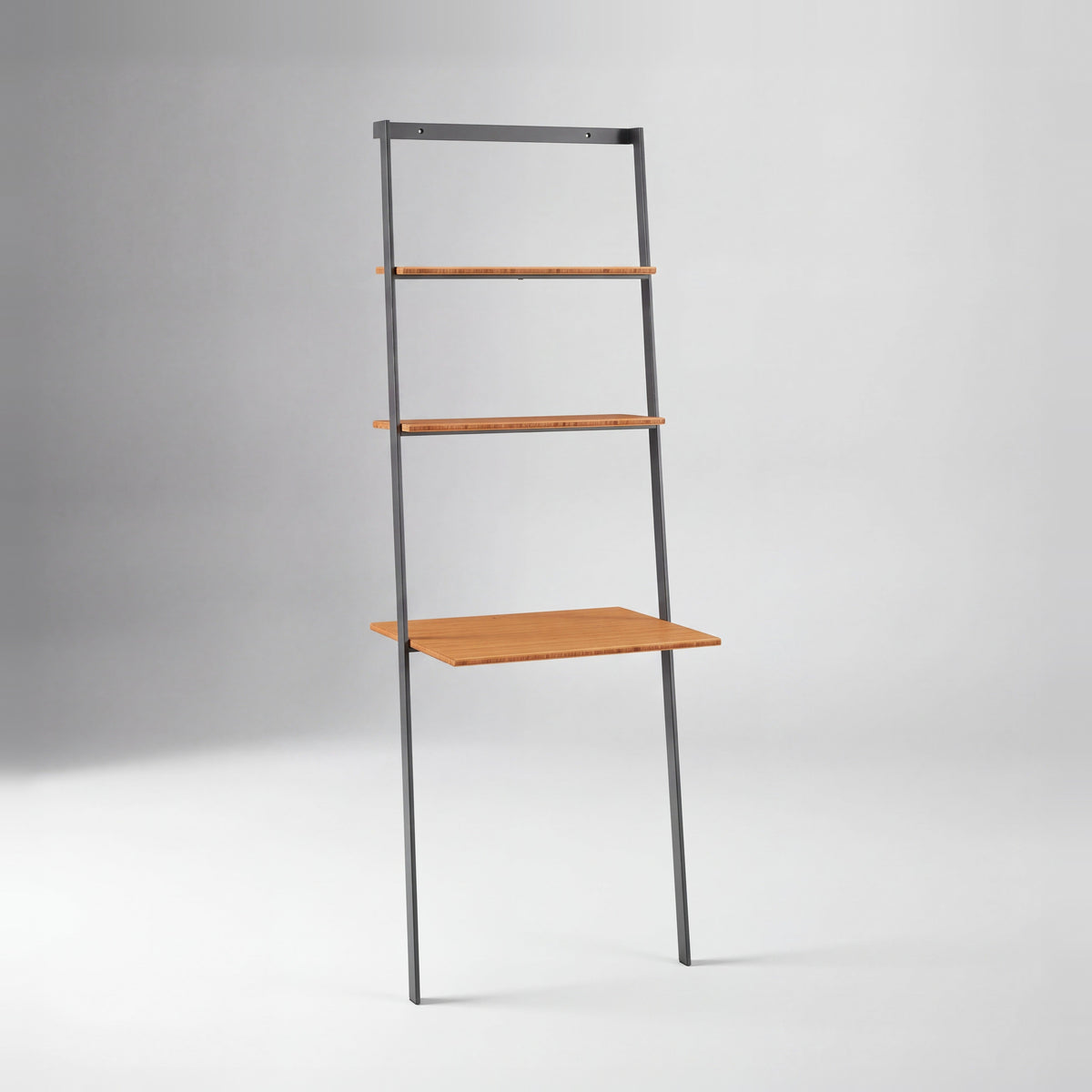 Greenington Studio Plus Leaning Desk in Amber bamboo, on a studio background