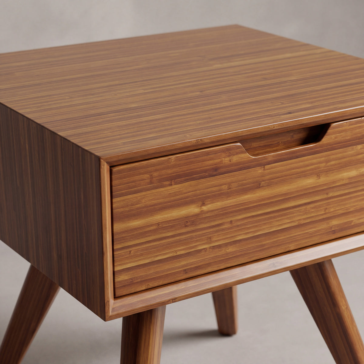 Close-up of the drawer and pull on the Greenington Summit Nightstand in Amber bamboo