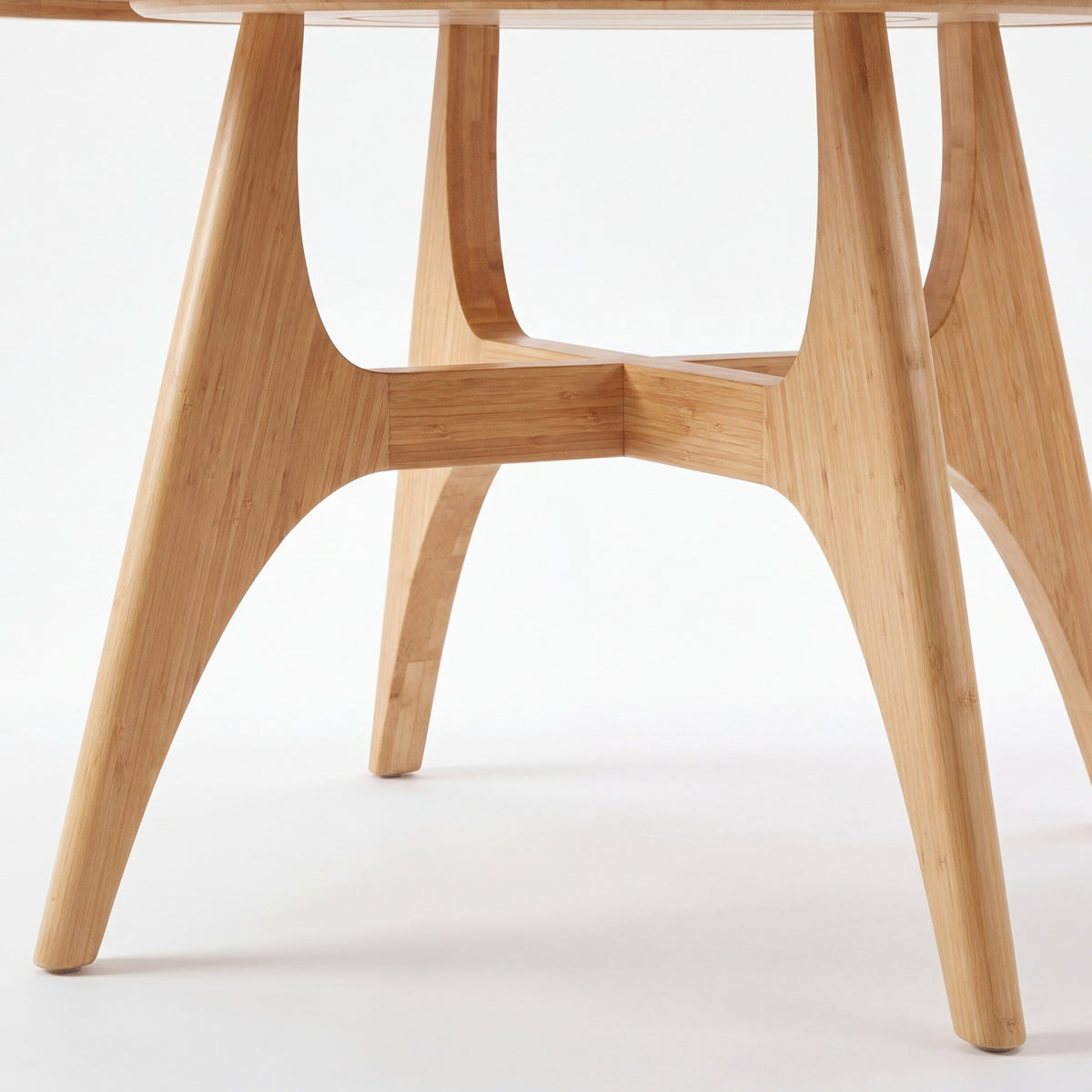 Close-up of the leg on the Greenington Suuri Dining Table in Caramelized bamboo