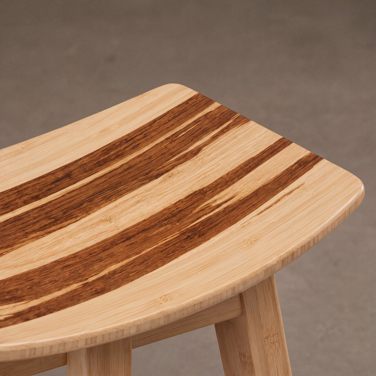 Close-up of the top and bamboo grain on the Greenington Tigris Counter Stool in Caramelized bamboo