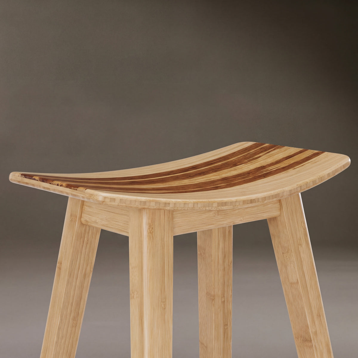 Close-up of the seat on the Greenington Tigris Counter Stool in Caramelized bamboo