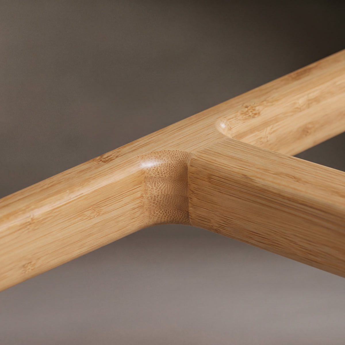 Close-up of the frame on the Greenington Tigris Counter Stool in Caramelized bamboo