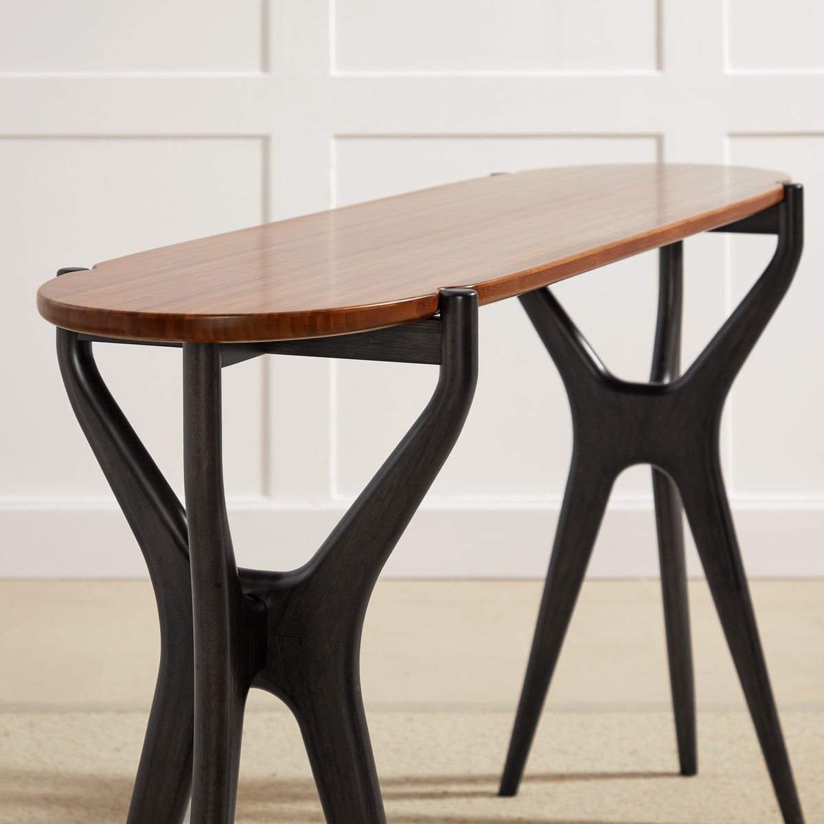 Detail of the leg on the Greenington Tofino Console Table in Amber and Caviar bamboo
