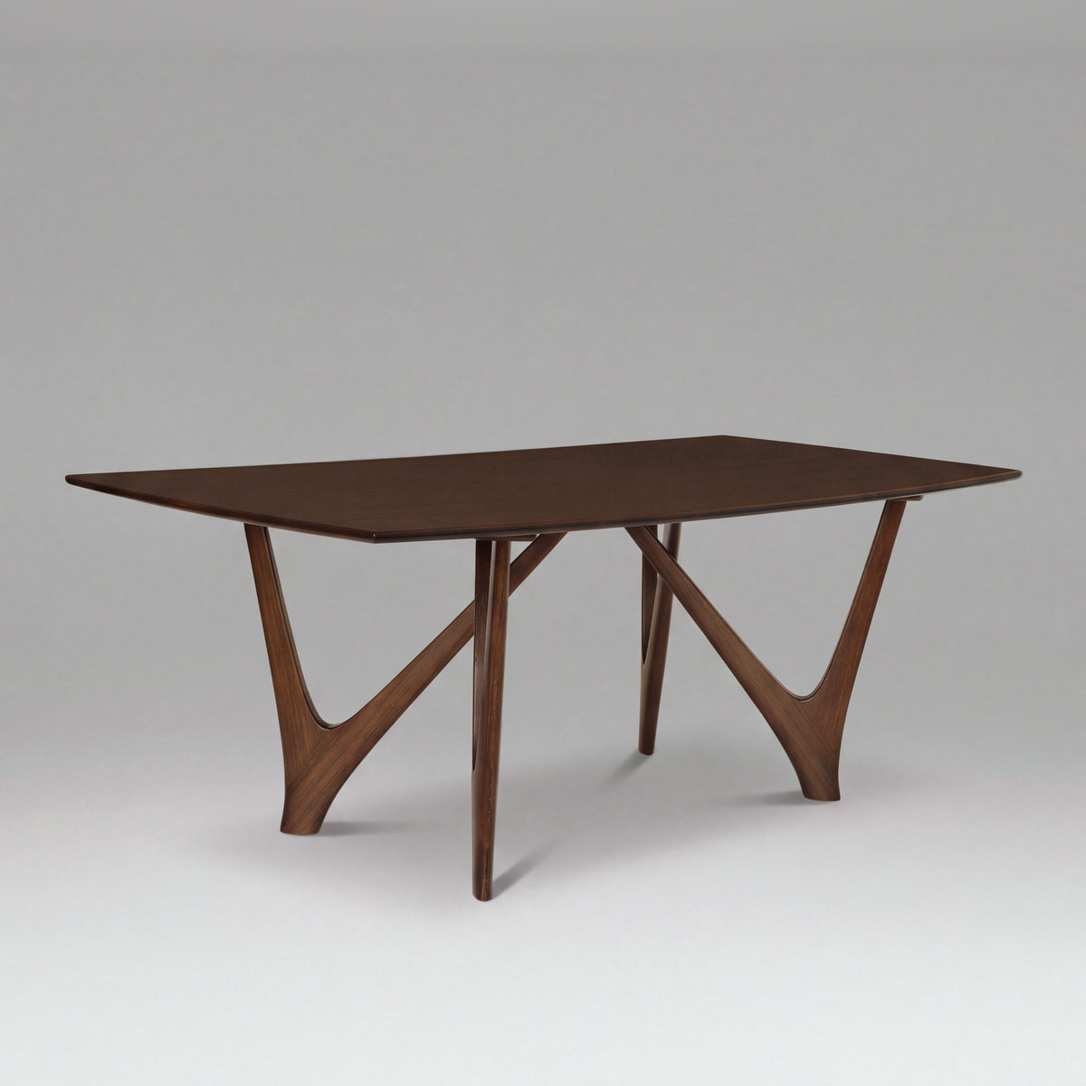 Greenington Vetra Dining Table in Black Walnut bamboo, on a studio backdrop, three-quarter view