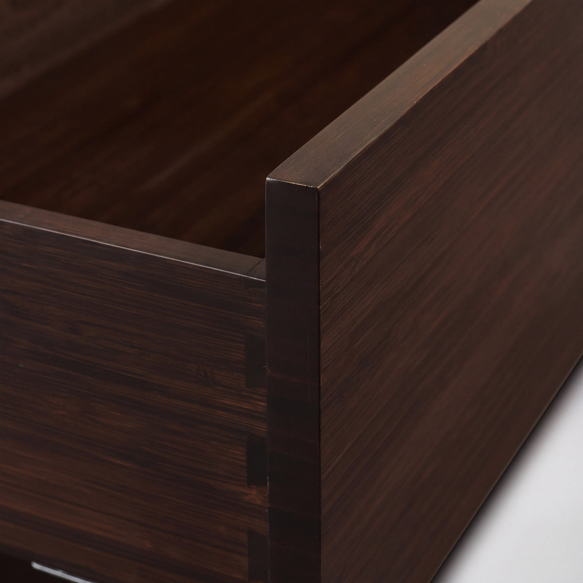 Detail of the corner joinery on the Greenington Weston Chest in Black Walnut bamboo